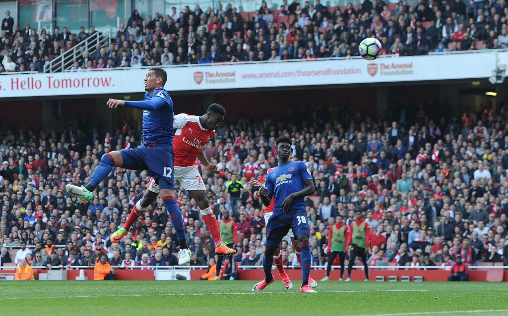 LONDON, ENGLAND - MAY 07: Danny Welbeck scores Arsenal's 2nd goal under pressure from Chris Smalling of Man Utd during the Premier League match between Arsenal and Manchester United at Emirates Stadium on May 7, 2017 in London, England. (Photo by David Price/Arsenal FC via Getty Images) *** Local Caption *** Danny Welbeck; Chris Smalling