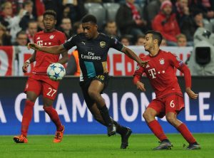 MUNICH, GERMANY - NOVEMBER 04: Alex Iwobi of Arsenal breaks past Thiago of Bayern Munich during the UEFA Champions League Group Stage match between Bayern Muenchen and Arsenal at the Allianz Arena on November 4, 2015 in Munich, Germany. (Photo by Stuart MacFarlane/Arsenal FC via Getty Images *** Local Caption *** Alex Iwobi;Thiago