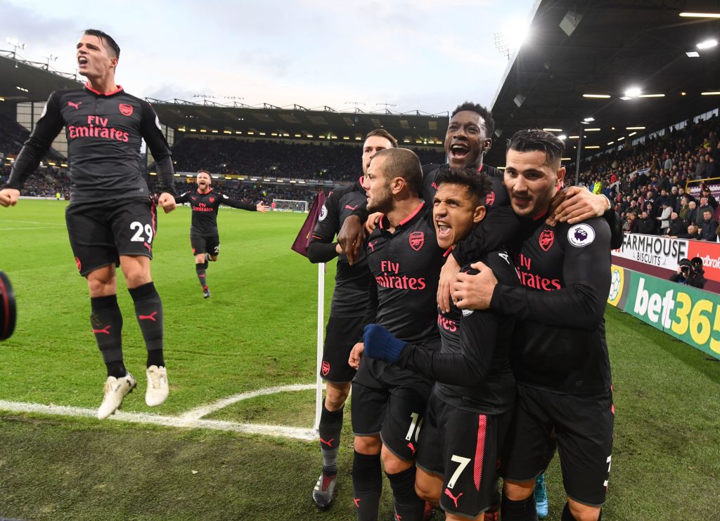BURNLEY, ENGLAND - NOVEMBER 26:  (2ndR) Alexis Sanchez celebrates scoring the Arsenal goal with (R) Sead Kolasinac (3rdL) Danny Welbeck (4thL) Jack Wilshere and (L) Granit Xhaka during the Premier League match between Burnley and Arsenal at Turf Moor on November 26, 2017 in Burnley, England.  (Photo by Stuart MacFarlane/Arsenal FC via Getty Images)