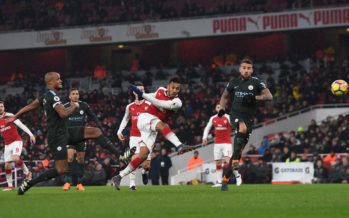 LONDON, ENGLAND - MARCH 01: Pierre-Emerick Aubameyang of Arsenal shoots under pressure from Vincent Kompany and Nicolas Otamendi of Man City during the Premier League match between Arsenal and Manchester City at Emirates Stadium on March 1, 2018 in London, England. (Photo by David Price/Arsenal FC via Getty Images) *** Local Caption *** Pierre-Emerick Aubameyang;Nicolas Otamendi;Vincent Kompany