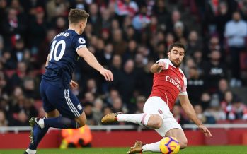 LONDON, ENGLAND - JANUARY 01: Sokratis of Arsenal clears the ball under pressure from Tom Cairney of Fulham during the Premier League match between Arsenal FC and Fulham FC at Emirates Stadium on January 1, 2019 in London, United Kingdom. (Photo by David Price/Arsenal FC via Getty Images) *** Local Caption *** Tom Cairney; Sokratis